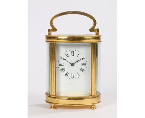 Asprey, a gilt brass carriage clock, the oval case with five bevelled glass panels, a white enamel dial and black Roman hours