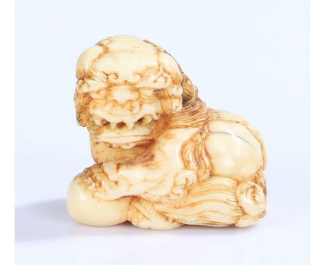 Japanese Meiji period ivory netsuke, Shishi with a paw on a ball, 3.5cm long