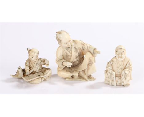 Japanese Meiji period ivory netsuke, of a seated figure about to gut a fish, 35mm high, together with a Meiji period seated f