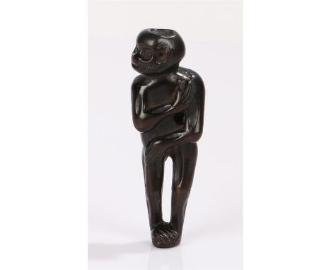 Japanese Meiji period hard wood netsuke, the netsuke carved as a standing monkey with arms across his body, signed, 7.5cm hig