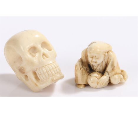 Japanese Meiji period netsuke, carved as a skull, 4cm high, together with a Japanese Meiji period ivory okimono carved as a s