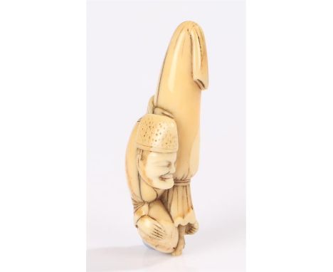 Japanese Meiji period ivory netsuke carved as a sleeping temple servant and curled up with an umbrella. length 6cm