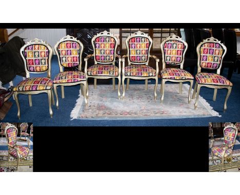 A Set of Six French Style Painted Dining Chairs To include x2 carvers and x4 dining chairs. Finished in pale gilt, upholstere