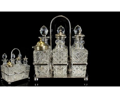 A Cut Glass And Stainless Steel Cruet Set Six piece vintage set in rectangular silver tone holder with central handle. Contai