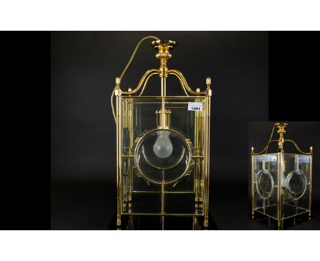 Carriage Style Ceiling Light  with brass casing and four glass panels . Single light bulb and measuring 22 inches in height.