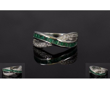 Emerald and Natural White Zircon Cross Band Ring, a row of channel set, square cut emeralds crossing over a row of prong set,