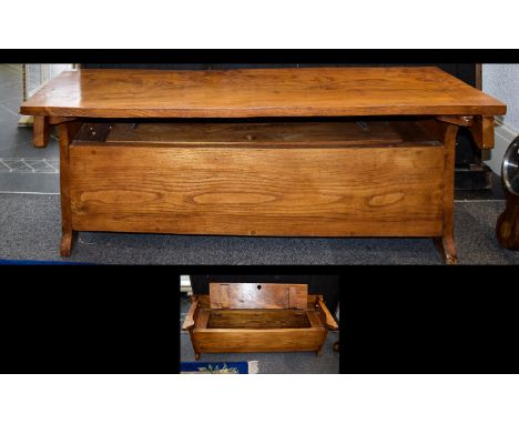 A Light Oak Monks Bench. Rustic style folding hall bench of solid construct and warm patina. Length 50 inches, height 19 inch