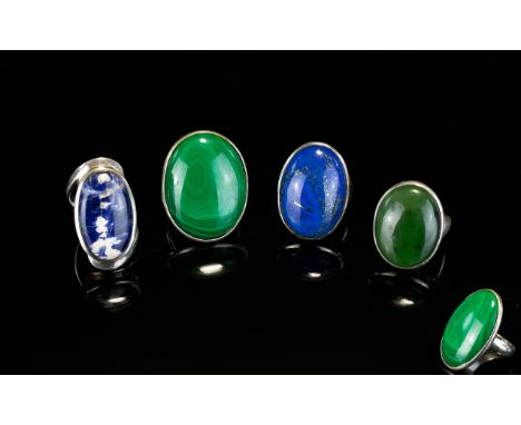 Four Silver And Crystal Set Rings A collection of oval cabouchon stone set rings the first set with large striated Malachite 