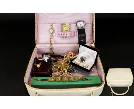 A Vintage Vanity Case Containing A Small Collection Of Costume Jewellery 1970's cream vinyl top zipped case with carry handle