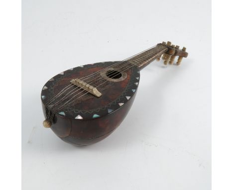 A 19th century miniature model, of a mandolin, decorated with tortoiseshell and mother of pearl, length 5.5ins
