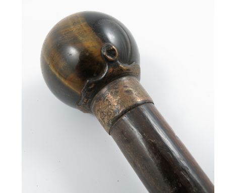 A 19th century walking stick, with tigers eye ball finial and hallmarked silver collar and mount, height 34ins