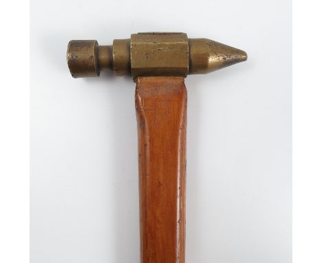 A novelty walking stick, with brass hammer head handle, the wooden shaft with brass plaque engraved J Logan, height 31.75ins