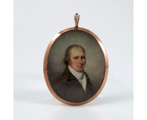 A 19th century oval portrait miniature, painted on ivory of a man with white cravat and brown jacket, in yellow metal frame w