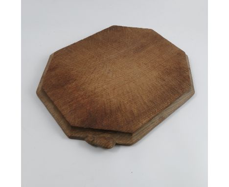 A Robert Mouseman Thompson bread board, the octagonal board carved with a mouse, width 12ins