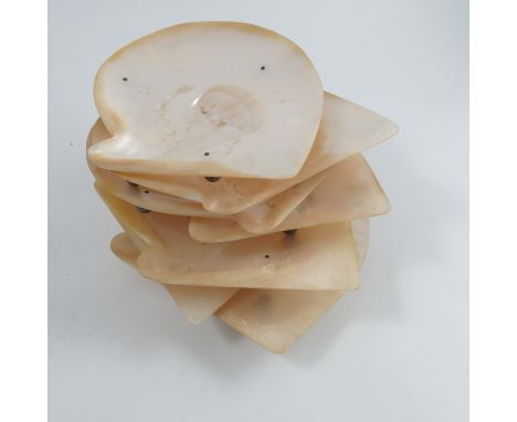 Eleven Oriental mother of pearl dishes, mounted on silver ball feet