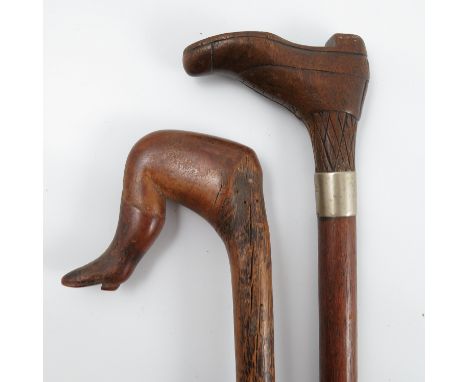 A walking stick, the handle formed as a shoe and sock, the sole of the shoe set with nail heads forming a heart, with silver 
