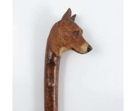 A walking stick, the handle carved and painted with a Fox Hound mask, height 41ins