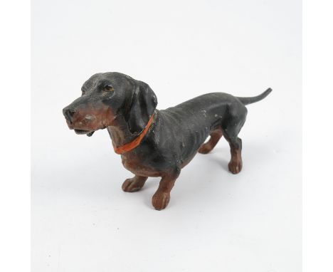 A cold painted model, of a dachshund, in black and tan, height 3ins