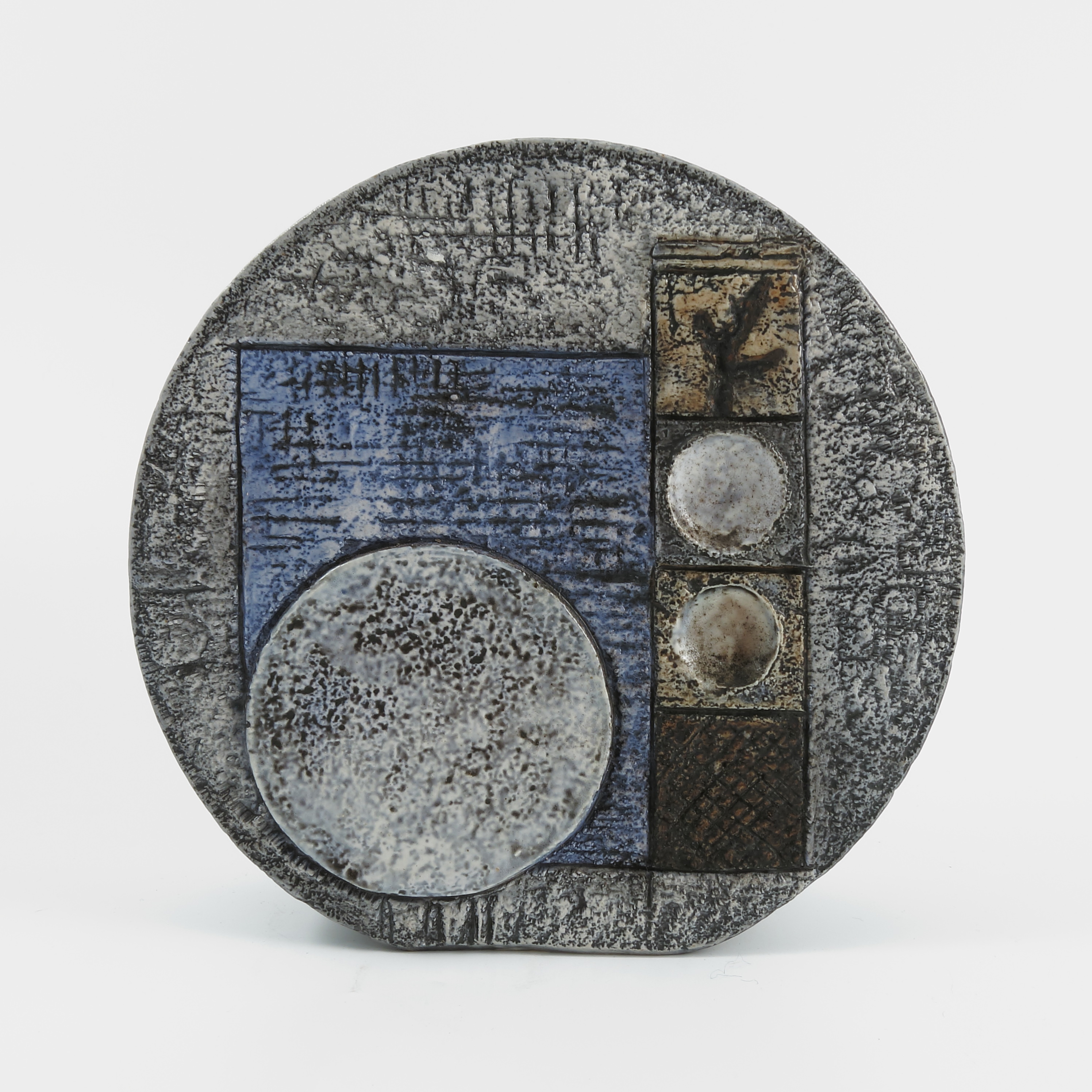 A Troika pottery circular vase, decorated with shapes to a green ground