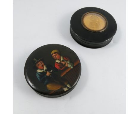 A 19th century black circular snuff box, the lid inset with a gilt plaque commemorating George III, diameter 3.5ins, together