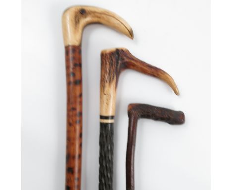 An antler horn handled walking stick, the ebonised shaft with inlaid and twist decoration, height 32.5ins, together with anot