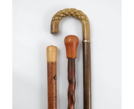 A 19th century malacca walking stick, with ivory pommel, height 43.5ins, together with another walking stick with twisted sha