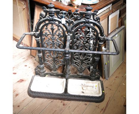 A Carron Falkirk cast iron stick stand, with pierced back and two drip trays, marked number 14, 36ins x 32ins x 11ins