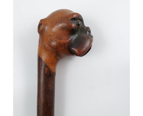 A wooden walking stick, the top carved with a Boxer dog mask, height 32ins