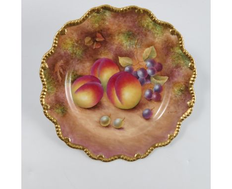 A Royal Worcester cabinet plate, decorated with fruit to a mossy background by P Stanley, to a shaped gilt edge, diameter 9in
