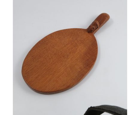 A Robert Mouseman Thompson cheese board, the oval board with handle, carved with a mouse, length 14.5ins