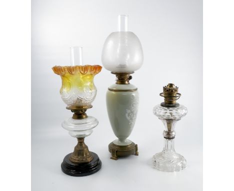 A Hink and Son oil lamp, the pale green porcelain body decorated in pate sur pate with a Classical motif, raised on a brass b
