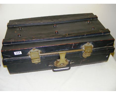 A metal trunk, with Shakespeare patent brass hinges and an red enamel interior.