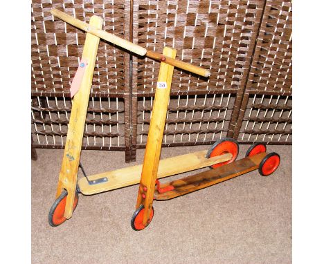Two vintage wooden scooters.