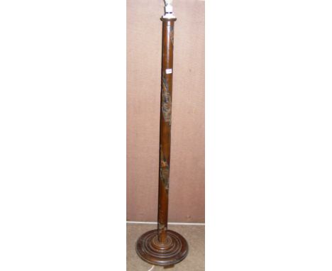 A carved oriental standard lamp.