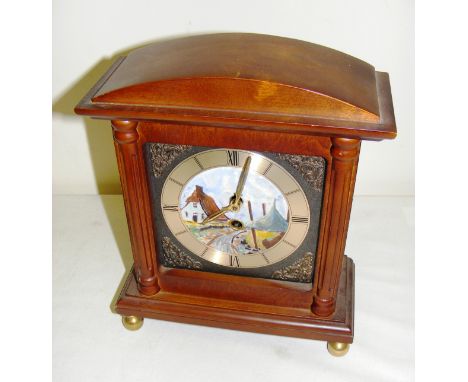 A modern wooden cased mantle clock with painted dial.