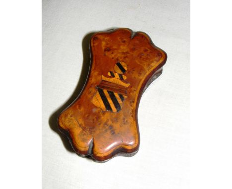 A walnut trinket box with inlaid crest & in an unusual shape in good condition, measuring 10.5cm long.
