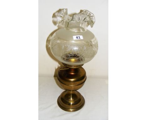 A Victorian brass oil lamp with a frilled glass shade measuring 49cm tall & in good condition, with no damage to the glass.