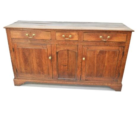 George III oak dresser base, George III oak dresser base, three plank top above one short and two long drawers, two single pa