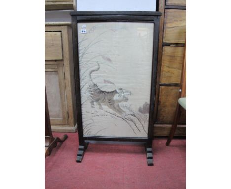 An Oriental Silk Pane,l featuring Growling Tiger, housed in a stained wooden fire screen, overall 92.5cm high.