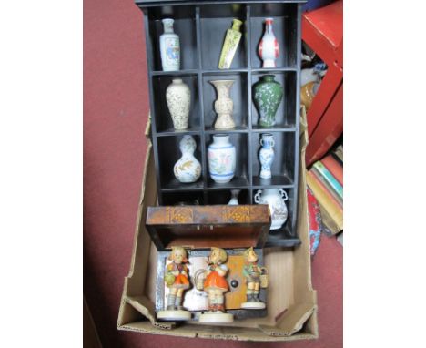 A XIX Century Walnut Tea Caddy, with marquetry decoration, miniature Oriental vases and stand and three Hummell figures:- One