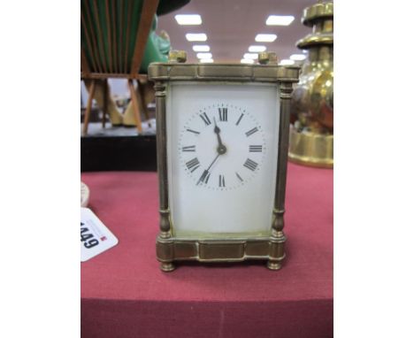 A XIX Century Brass Carriage Clock, French made, black Roman numerals to white dial, 12cm high with handle down.