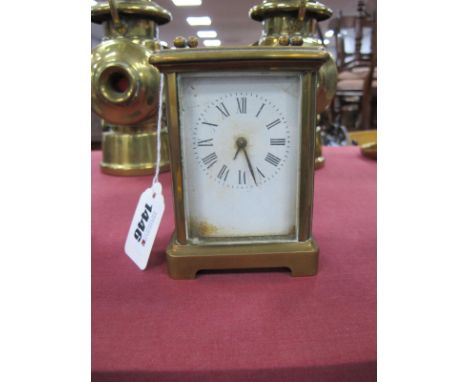 A Brass Cased Carriage Clock, black Roman numerals, to white dial, 11.5cm high with handle down.