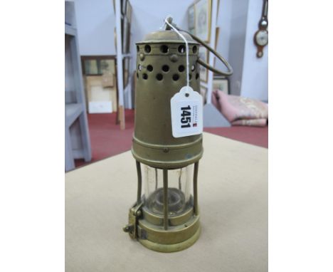 Davis Derby, Brass Miners Lamp, with three bands of cut circles near the top, 24.5cm high with handle down.