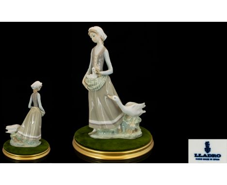 Lladro Large Porcelain Figure 'Girl with Goose'. model no 4815, Issued 1972-1991, height 12.25 inches/31 cms with circular di