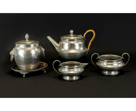 A Small Collection Of English Pewter By Homeland To include twin handle sugar bowl, rattan handle teapot, footed trivet, milk