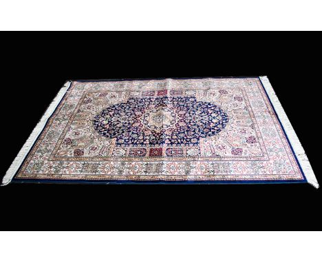 A Large Woven Silk Carpet Keshan rug with blue ground and traditional Middle Eastern floral and foliate border detail with ce