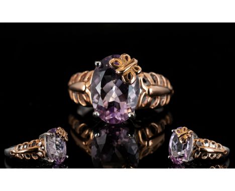 Rose de France Amethyst Butterfly Decorated Solitaire Ring, a 5.25ct oval cut Rose de France amethyst held to one corner by a