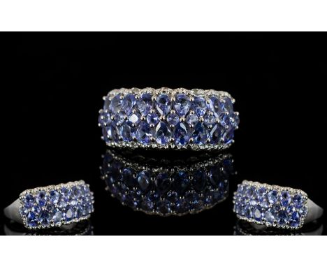 Tanzanite Three Row Band Ring, comprising two rows of pear cut tanzanites, closely set, with a row of round cut tanzanites in