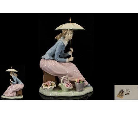 Nao by Lladro Handpainted Porcelain Figure 'Girl with Parasol' seated with baskets of flowers to feet. A30. 8.75 inches 22 cm