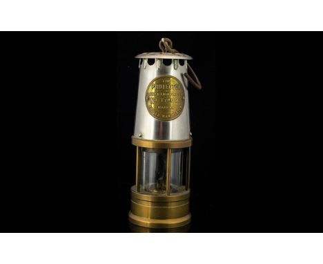 A Brass Miners Lamp Of typical form, height, 9 inches, embossed plaque to front 'The Protector Lamp a&amp; Lighting Co Ltd Ty